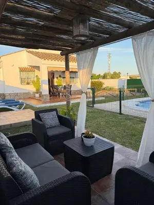 a patio with a couch and chairs and a table at casa lucia in Cádiz