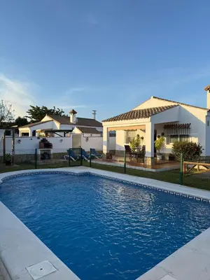 a swimming pool in front of a house at casa lucia in Cádiz