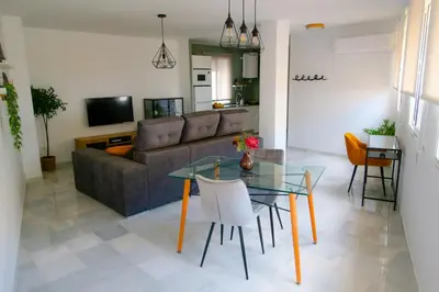 a living room with a glass table and a couch at Sherryflat Atípika in Jerez de la Frontera