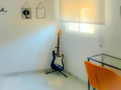 a guitar hanging on a wall in a room at Sherryflat Atípika in Jerez de la Frontera