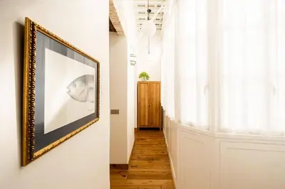 a hallway with a framed picture on a wall at La Posada de Juan in Cádiz