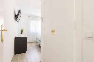 a door leading into a room with a bedroom at RONDA DE MULEROS 6 in Jerez de la Frontera