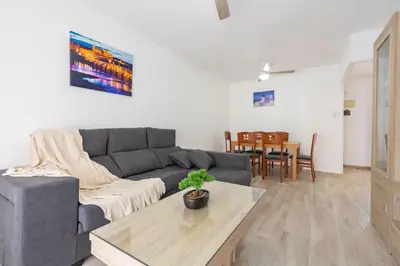 a living room with a couch and a table at RONDA DE MULEROS 6 in Jerez de la Frontera