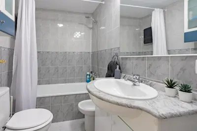 a bathroom with a sink and a toilet and a tub at RONDA DE MULEROS 6 in Jerez de la Frontera