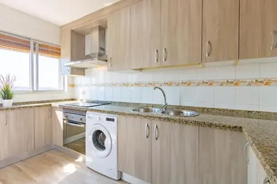 a kitchen with a sink and a washing machine at RONDA DE MULEROS 6 in Jerez de la Frontera