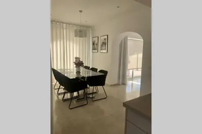 a dining room with a glass table and black chairs at Villa exclusiva con piscina privada, La Tina Golf in Arcos de la Frontera
