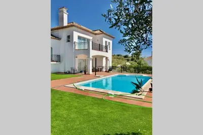 a villa with a swimming pool in front of a house at Villa exclusiva con piscina privada, La Tina Golf in Arcos de la Frontera