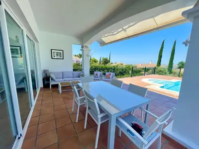 a patio with a table and chairs and a pool at Villa exclusiva con piscina privada, La Tina Golf in Arcos de la Frontera