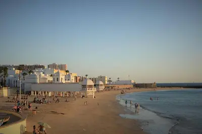 a group of people on a beach near the water at Esencia de Cádiz Entre la Viña y el mercado in Cádiz
