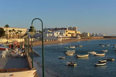 a group of boats in the water near a beach at Esencia de Cádiz Entre la Viña y el mercado in Cádiz