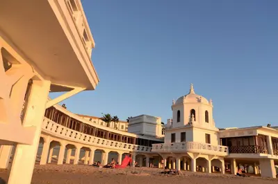 a building with a clock tower on a beach at Esencia de Cádiz Entre la Viña y el mercado in Cádiz