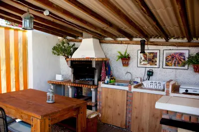 a kitchen with a table and a stove top oven at Cortijo Flamingos in Chiclana de la Frontera