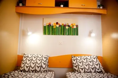 a room with two pillows and a painting of flowers at Cortijo Flamingos in Chiclana de la Frontera