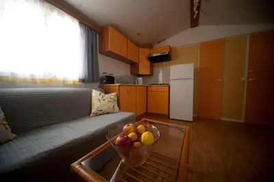 a living room with a bowl of fruit on a table at Cortijo Flamingos in Chiclana de la Frontera
