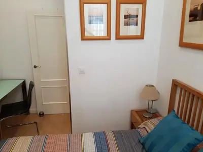 a glass shower in a bathroom with a table at Cozy Apartment in Cádiz with Terrace in Cádiz