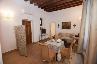 a living room with a table and a couch at Patios de la Riva in Jerez de la Frontera