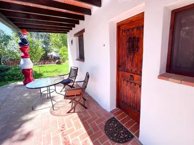 a patio with a table and chairs and a door at La Casita de Los Alambiques in Chiclana de la Frontera