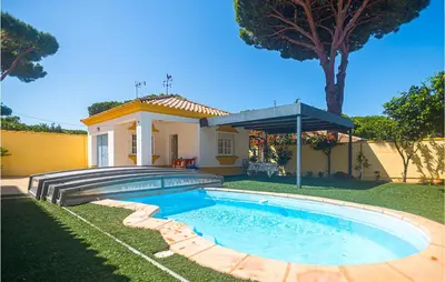 a swimming pool in the yard of a house at Lovely Home In Chiclana De La Fronter in Cádiz