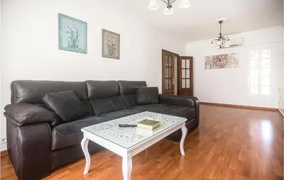 a living room with a couch and a coffee table at Lovely Home In Chiclana De La Fronter in Cádiz