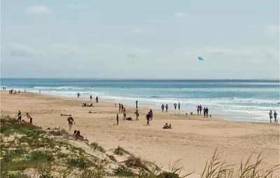 a group of people on a beach near the ocean at Lovely Home In Chiclana De La Fronter in Cádiz