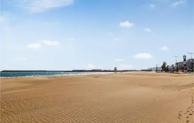 a beach with footprints in the sand and the ocean at Lovely Home In Chiclana De La Fronter in Cádiz