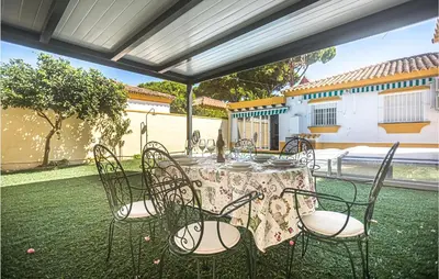 a table with chairs and a tablecloth on a patio at Lovely Home In Chiclana De La Fronter in Cádiz