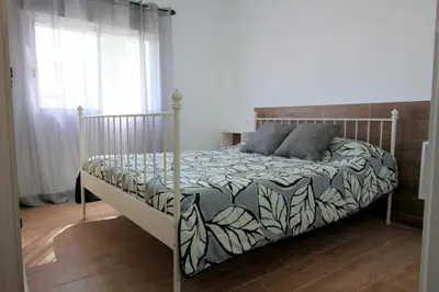 a bed in a bedroom with at Apartamento Mercedes Céntrico Playa in Sanlúcar de Barrameda