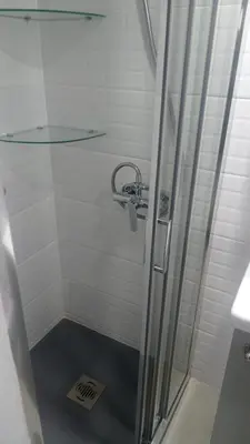 a shower with a glass door in a bathroom at Apartamento Mercedes Céntrico Playa in Sanlúcar de Barrameda