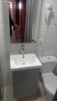a bathroom with a sink and a toilet and a mirror at Apartamento Mercedes Céntrico Playa in Sanlúcar de Barrameda