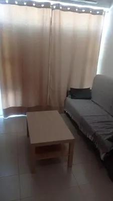 a living room with a couch and a coffee table at Apartamento Mercedes Céntrico Playa in Sanlúcar de Barrameda