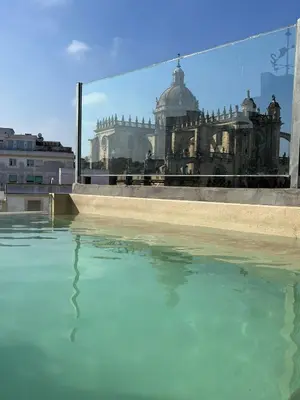 a pool of water with a view of a building at Catedral Suites Jerez in Jerez de la Frontera