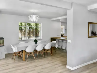 a white dining room with a table and chairs at Villa Alamos Jerez I Piscina Salada Climatizada I BBQ I Jardines I 850m2 in Jerez de la Frontera