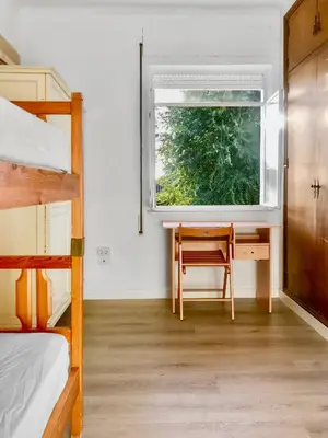 a bedroom with a desk and a window and a bunk bed at Villa Alamos Jerez I Piscina Salada Climatizada I BBQ I Jardines I 850m2 in Jerez de la Frontera