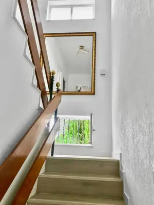 a stairway with a mirror on the wall at Villa Alamos Jerez I Piscina Salada Climatizada I BBQ I Jardines I 850m2 in Jerez de la Frontera