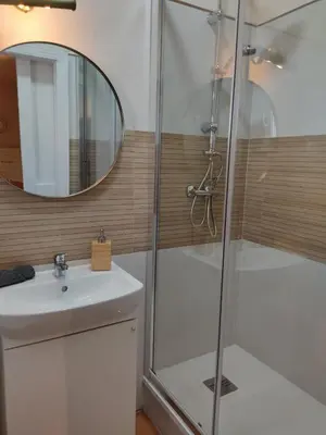a bathroom with a shower and a sink and a mirror at Apartamento la Capillita in Sanlúcar de Barrameda