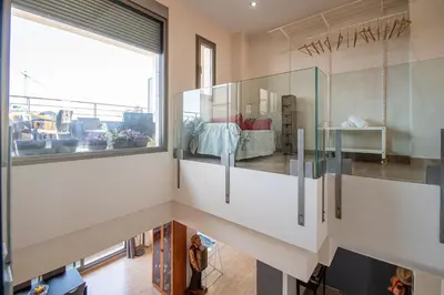 a living room with a large window at Loft Space - Time in Cádiz in Cádiz