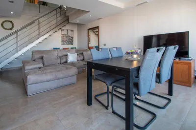 a living room with a table and a couch at Loft Space - Time in Cádiz in Cádiz