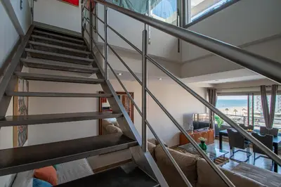 a staircase in a house with a living room at Loft Space - Time in Cádiz in Cádiz
