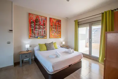a bedroom with a bed and a large window at Loft Space - Time in Cádiz in Cádiz