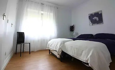 a bedroom with a large bed and a window at Villas Aloha Valdelagrana in El Puerto de Santa María