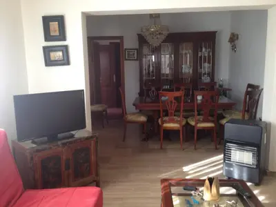 a living room with a tv and a dining room at Villas Aloha Valdelagrana in El Puerto de Santa María