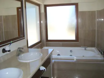 a bathroom with two sinks and a bath tub at Villas Aloha Valdelagrana in El Puerto de Santa María