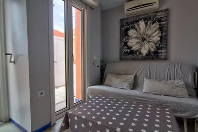 a living room with a couch and a window at Apartamentos Aloha2 El Puerto de Santa Maria in El Puerto de Santa María