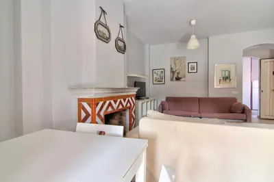 a living room with a couch and a fireplace at Apartamentos Aloha2 El Puerto de Santa Maria in El Puerto de Santa María