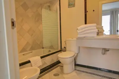 a bathroom with a toilet and a sink and a shower at Apartamentos Aloha2 El Puerto de Santa Maria in El Puerto de Santa María
