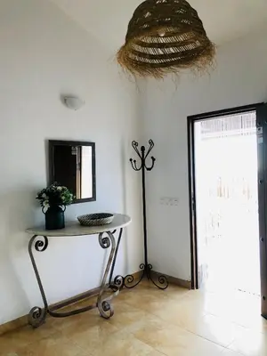 a room with a table and a mirror on the wall at Casa Con Encanto Solo Familia in Conil de la Frontera