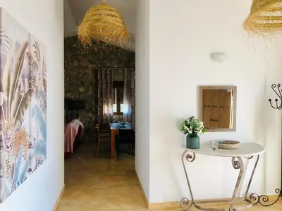 a hallway with a table and a dining room at Casa Con Encanto Solo Familia in Conil de la Frontera