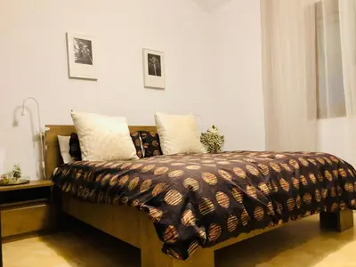 a bed with a brown blanket and pillows on it at Casa Con Encanto Solo Familia in Conil de la Frontera