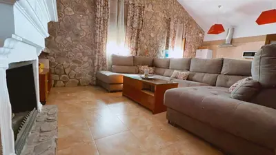 a living room with a couch and a tv at Casa Con Encanto Solo Familia in Conil de la Frontera