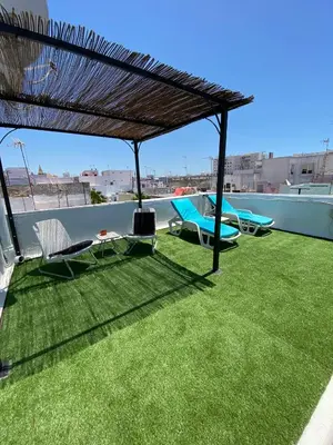 a patio with grass and chairs on a roof at Apartamentos El BALNEARIO by Cadiz4Rentals in Cádiz